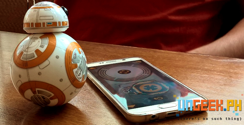 BB-8 checks his controls -- well and the phone as well. :D